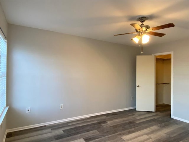 spare room featuring dark hardwood / wood-style floors and ceiling fan