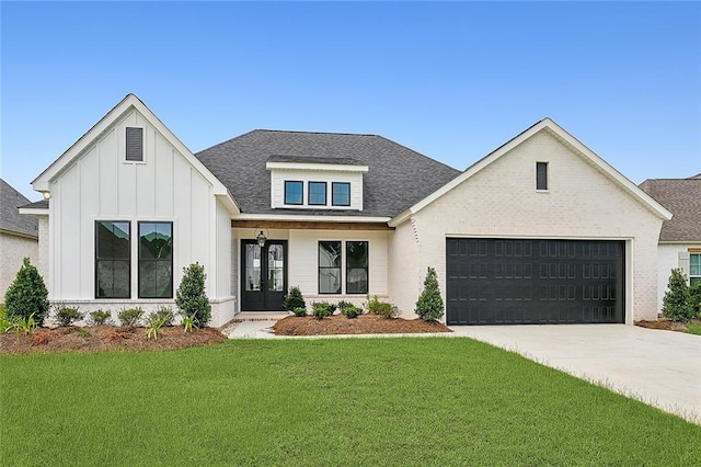 modern inspired farmhouse with a garage and a front yard