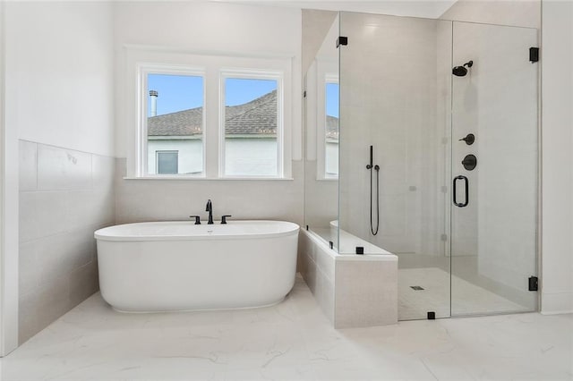 bathroom featuring separate shower and tub