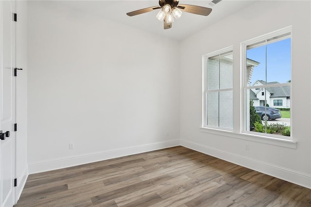 unfurnished room featuring hardwood / wood-style flooring and ceiling fan