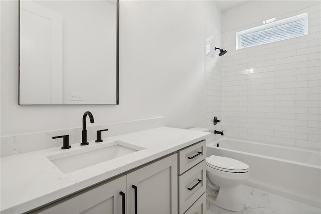 full bathroom with tiled shower / bath, vanity, and toilet