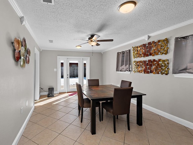 dining room featuring crown molding, light tile patterned floors, ceiling fan, and french doors