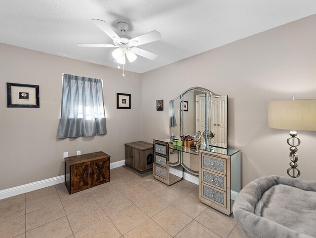 sitting room with ceiling fan and light tile patterned flooring