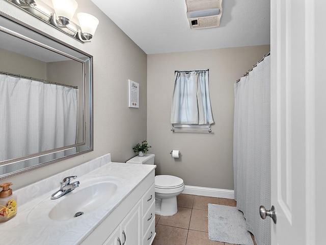 bathroom with vanity, toilet, and tile patterned flooring