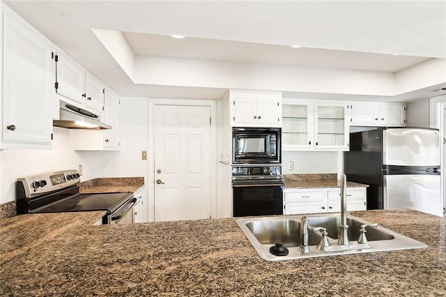 kitchen with white cabinetry, a tray ceiling, sink, and black appliances