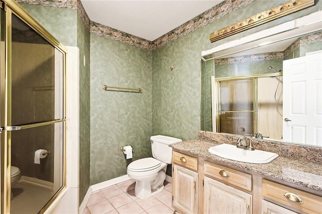 bathroom with vanity, toilet, and tile patterned flooring