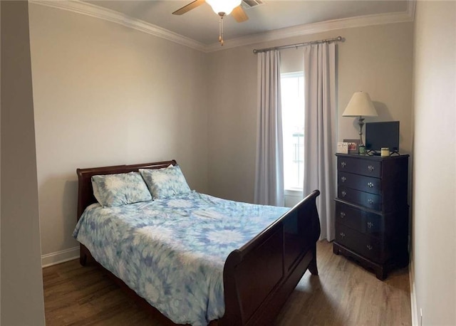 bedroom with dark wood-type flooring, ceiling fan, and crown molding