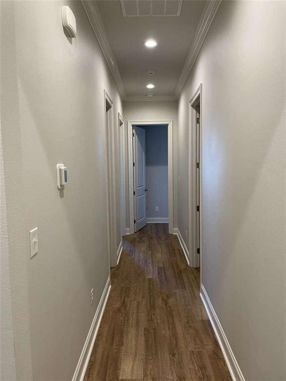 corridor featuring ornamental molding and dark hardwood / wood-style flooring