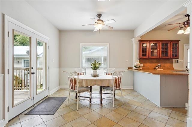 dining space featuring plenty of natural light, light tile patterned floors, and ceiling fan