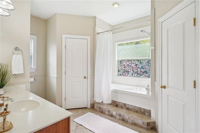 bathroom with vanity, tile patterned flooring, and a bathing tub