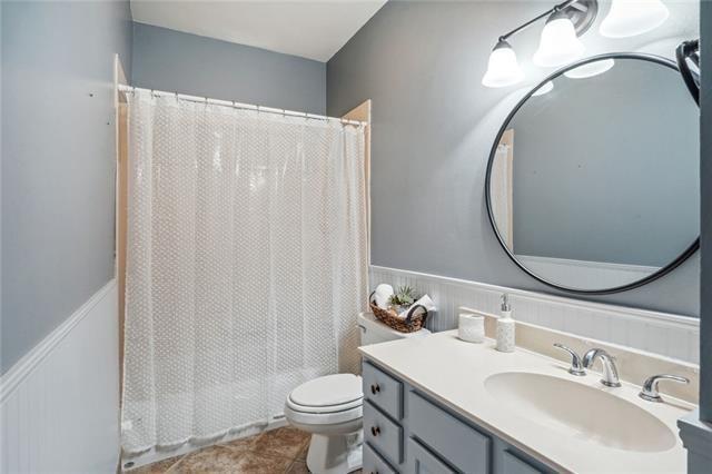 bathroom featuring vanity, toilet, and tile patterned flooring