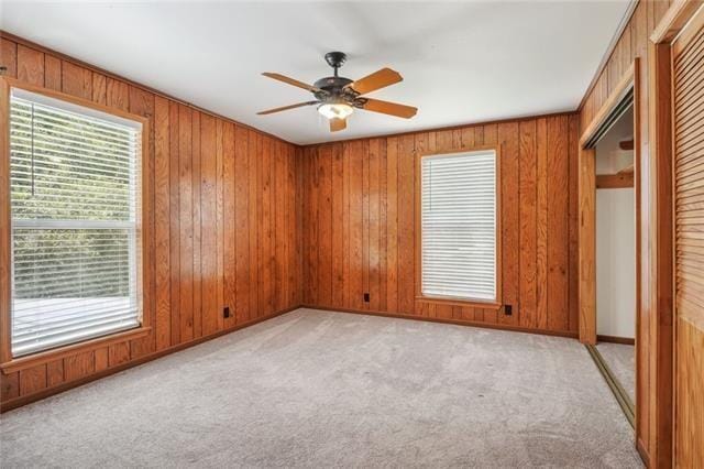 carpeted spare room with ceiling fan