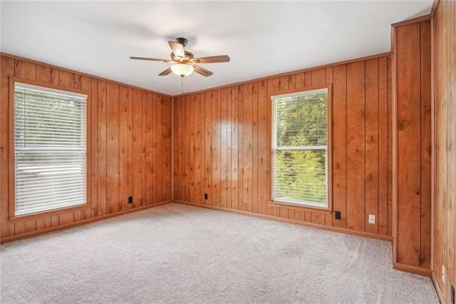 spare room featuring ceiling fan and light colored carpet