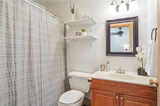 bathroom with vanity, a chandelier, and toilet