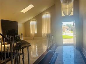 7110 Camberley Dr, New Orleans, LA 70128 - hall with lofted ceiling, a skylight, and baseboards