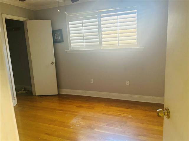 7110 Camberley Dr, New Orleans, LA 70128 - unfurnished bedroom with light wood-style floors, baseboards, and crown molding