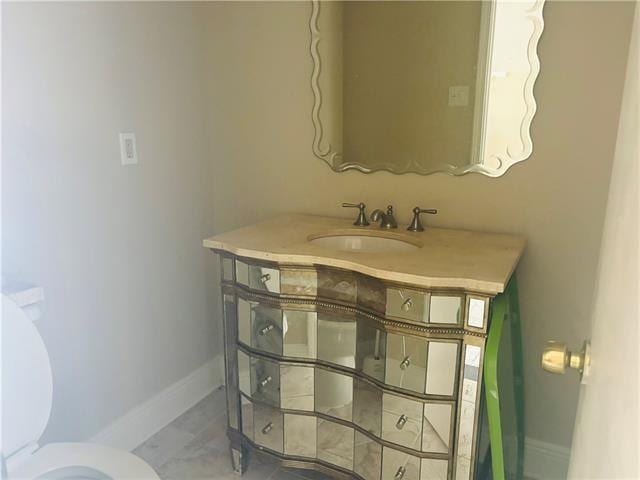 7110 Camberley Dr, New Orleans, LA 70128 - bathroom featuring baseboards, toilet, and vanity