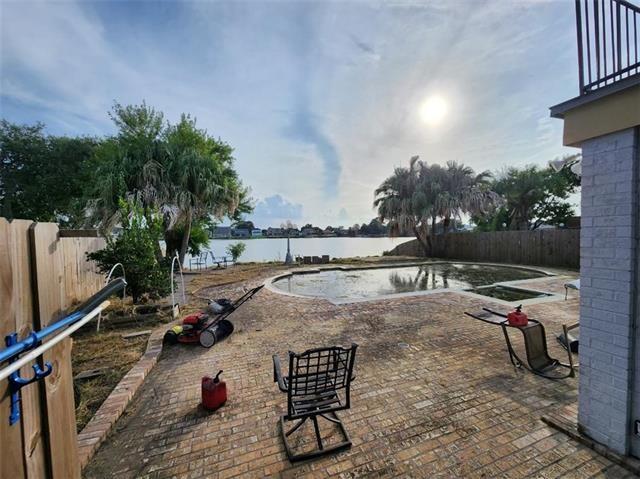 7110 Camberley Dr, New Orleans, LA 70128 - view of pool featuring a water view, a patio, and a fenced backyard