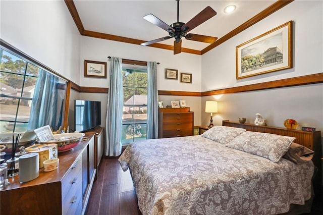 bedroom with crown molding, dark hardwood / wood-style floors, and ceiling fan