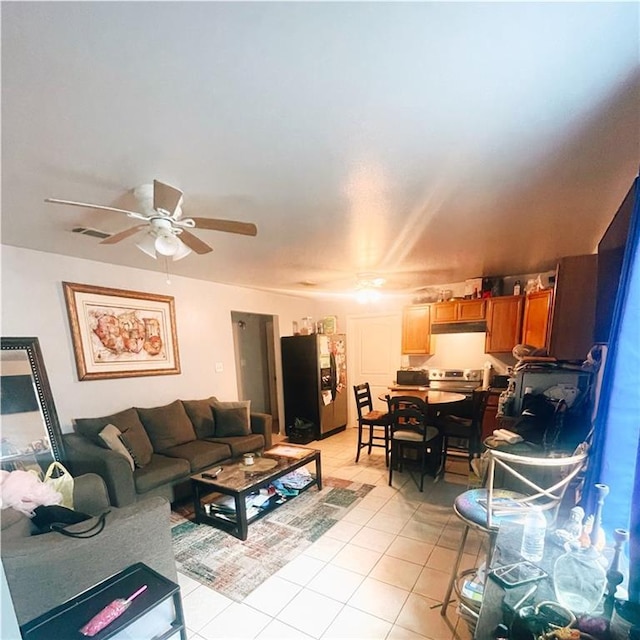 tiled living room featuring ceiling fan