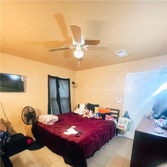 bedroom with light tile patterned floors and ceiling fan