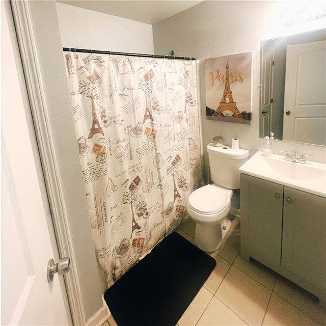 bathroom featuring vanity, toilet, and tile patterned flooring