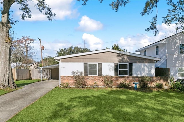 single story home featuring a front yard and a carport