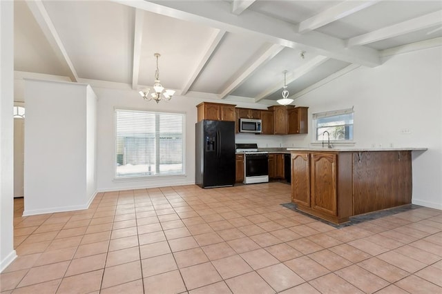 kitchen featuring pendant lighting, black fridge with ice dispenser, kitchen peninsula, and gas range gas stove