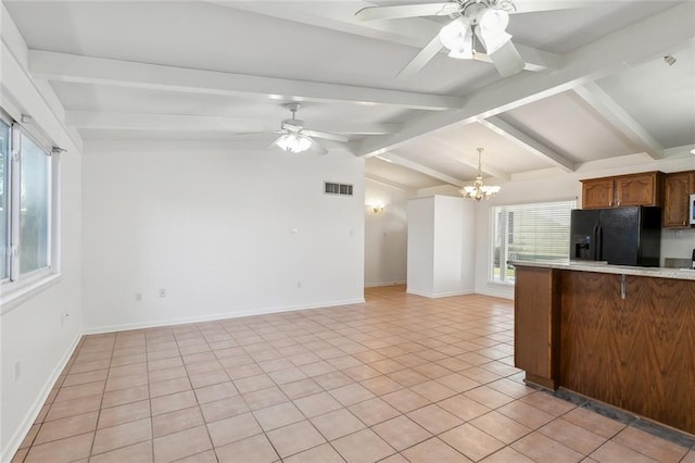 kitchen featuring lofted ceiling with beams, light tile patterned flooring, ceiling fan with notable chandelier, black refrigerator with ice dispenser, and kitchen peninsula