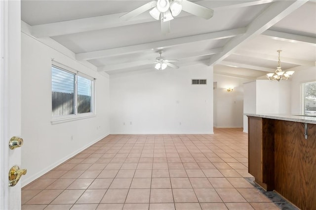 empty room with ceiling fan with notable chandelier, lofted ceiling with beams, and light tile patterned flooring