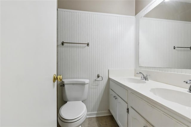 bathroom with vanity, toilet, and tile patterned flooring