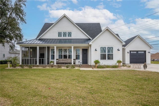 view of front facade featuring a garage, a sunroom, and a front lawn