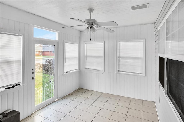 unfurnished sunroom featuring ceiling fan