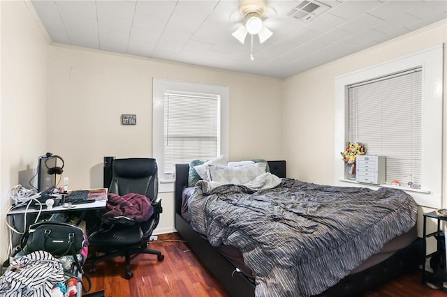 bedroom featuring ornamental molding, dark hardwood / wood-style floors, and ceiling fan