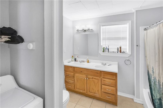 bathroom featuring tile patterned floors, toilet, washer / clothes dryer, and vanity