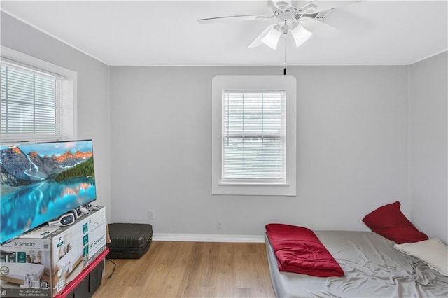 bedroom with ceiling fan and light hardwood / wood-style floors