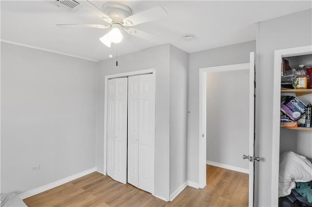 bedroom featuring ceiling fan, a closet, and light wood-type flooring