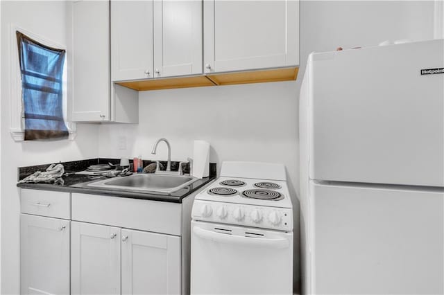 kitchen with white cabinetry, white appliances, and sink