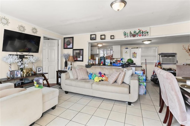 living room featuring light tile patterned flooring, ornamental molding, and a wall unit AC