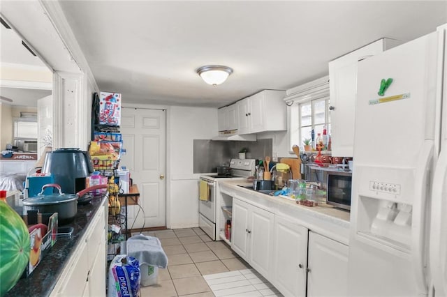 kitchen featuring white cabinetry, sink, light tile patterned floors, and white appliances