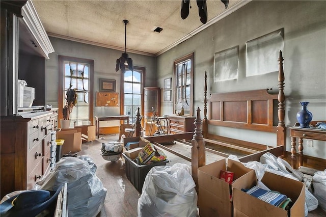 miscellaneous room with wood-type flooring, a textured ceiling, and crown molding