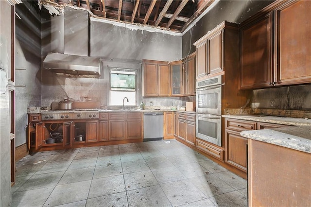 kitchen featuring sink, light stone countertops, and appliances with stainless steel finishes