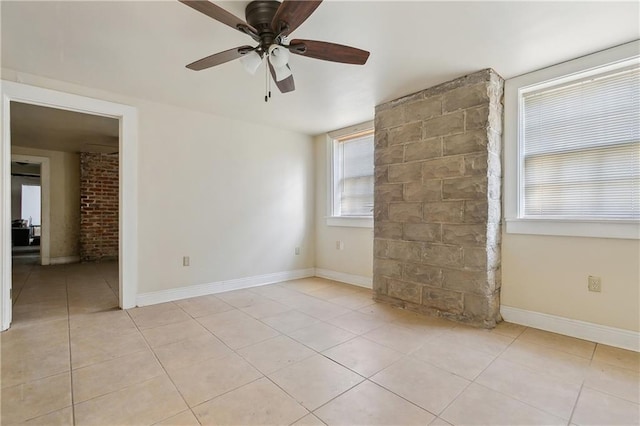 tiled spare room with ceiling fan