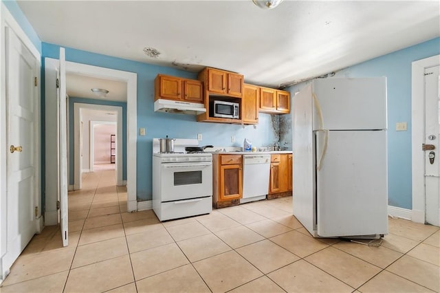 kitchen with white appliances and light tile patterned floors