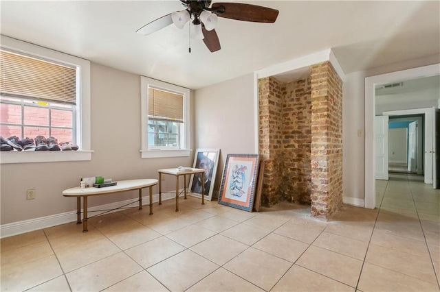 spare room featuring light tile patterned flooring and ceiling fan