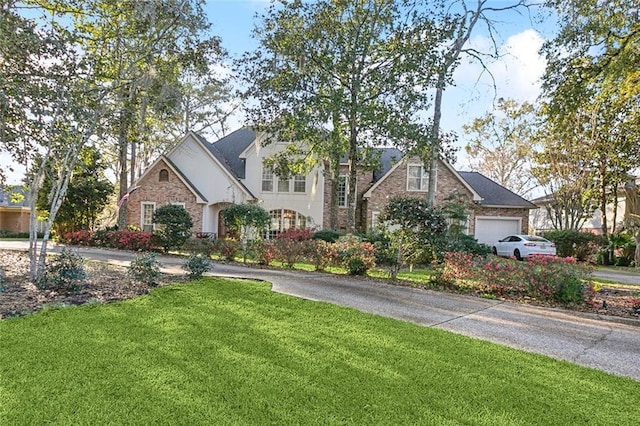 view of front facade featuring a garage and a front lawn