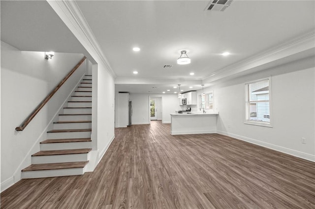 unfurnished living room with ornamental molding, dark hardwood / wood-style floors, and sink