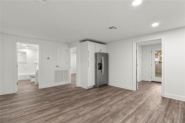 unfurnished living room with wood-type flooring