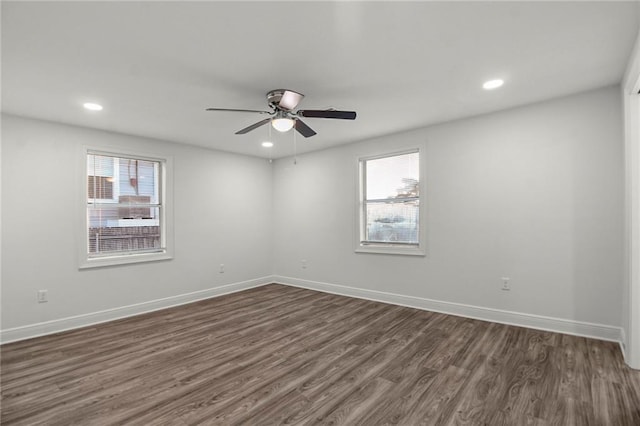 unfurnished room with dark wood-type flooring and ceiling fan