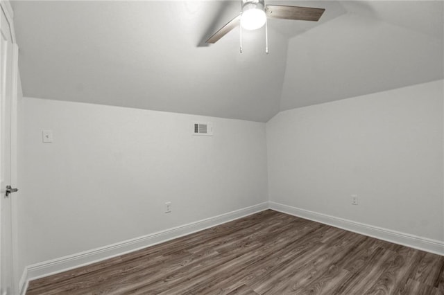 additional living space featuring vaulted ceiling, ceiling fan, and dark hardwood / wood-style flooring